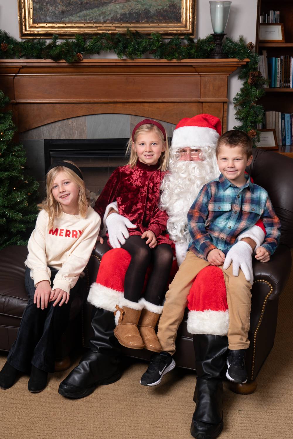 Three kids sitting with Santa.